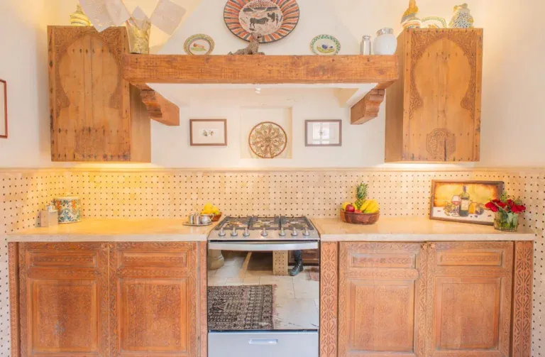 Casa Kate, kitchen with wood cabinets, tile counters and a gas range, San Miguel de Allende