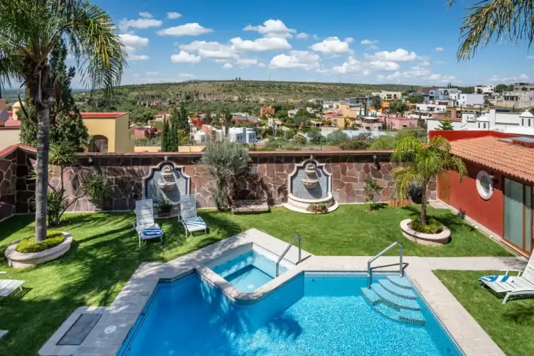 Casa La Colina, aerial view of the pool courtyard with the town beyond, San Miguel de Allende