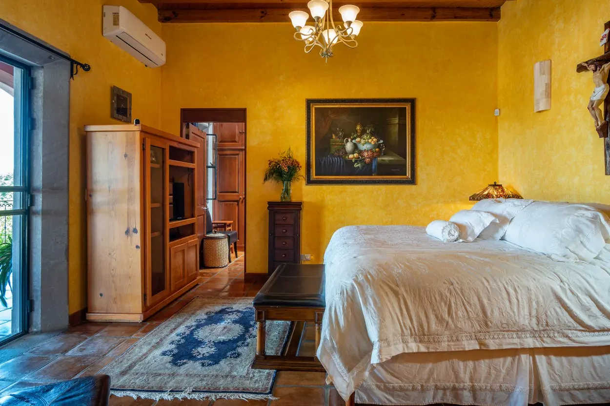 Casa La Colina, primary bedroom with a white bed and large windows, San Miguel de Allende