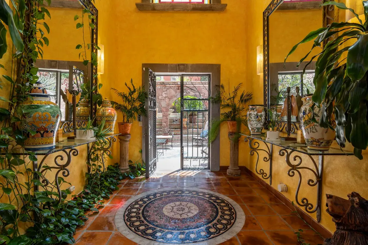 Casa La Colina, entry hall with iron railings and a mosaic floor medallion, San Miguel de Allende