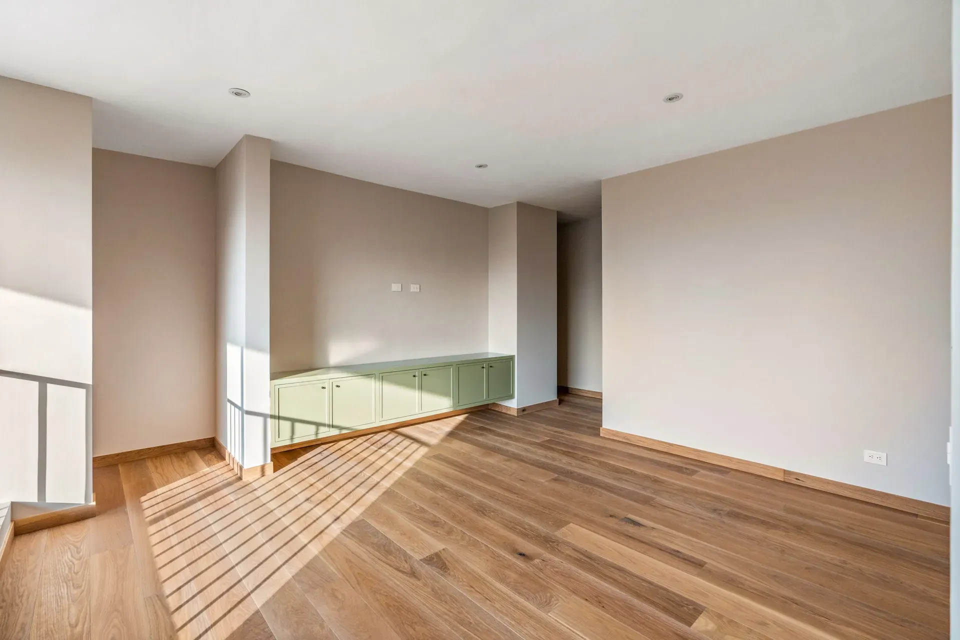 Casa Lavanda, empty upper room with oak floors, a green built-in cabinet and a stair opening, San Miguel de Allende