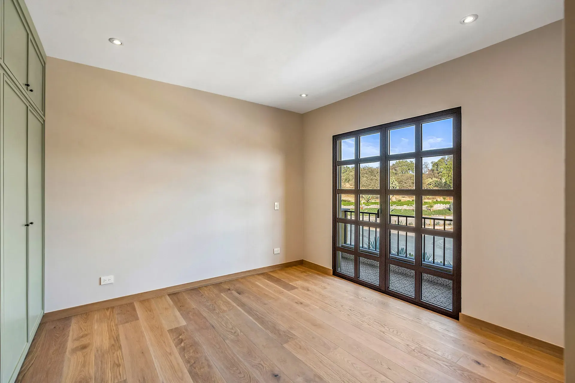 Casa Lavanda, empty bedroom with a window door onto a balcony with a view of a golf course, San Miguel de Allende