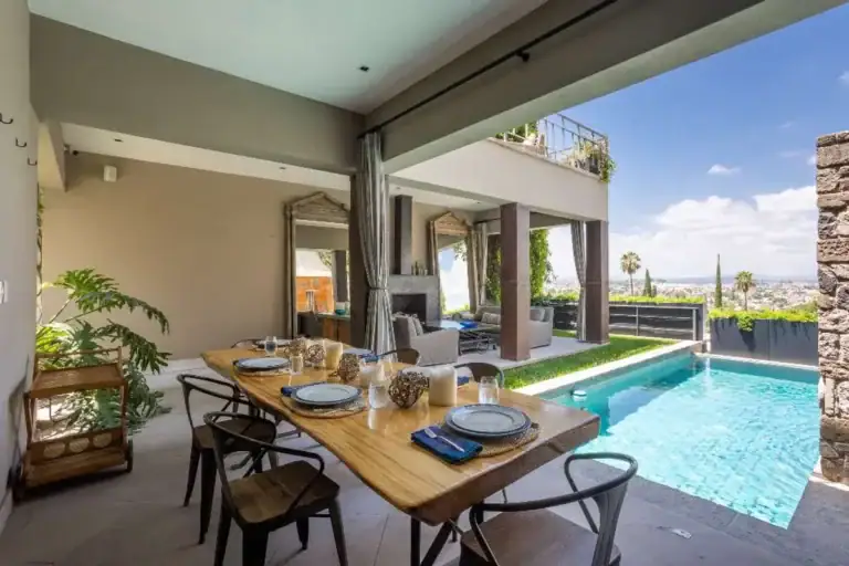 Casa Lily, covered dining table beside the pool with a view of the city, San Miguel de Allende