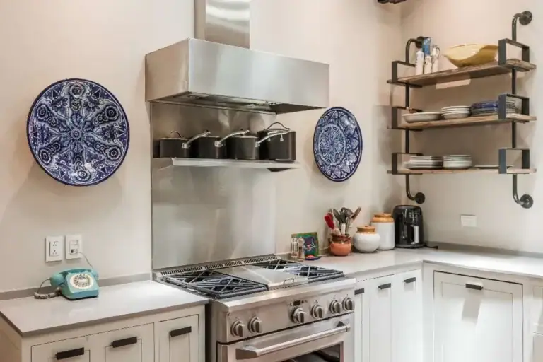 Casa Lily, kitchen with a stainless range, open shelves and decorative plates, San Miguel de Allende