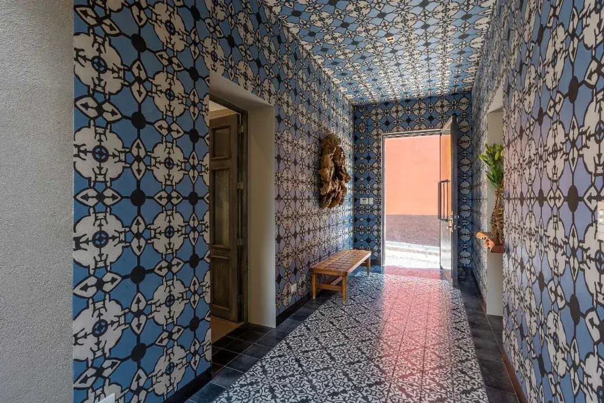 Casa Lily, hallway with blue and white patterned tile on the walls and floor, San Miguel de Allende