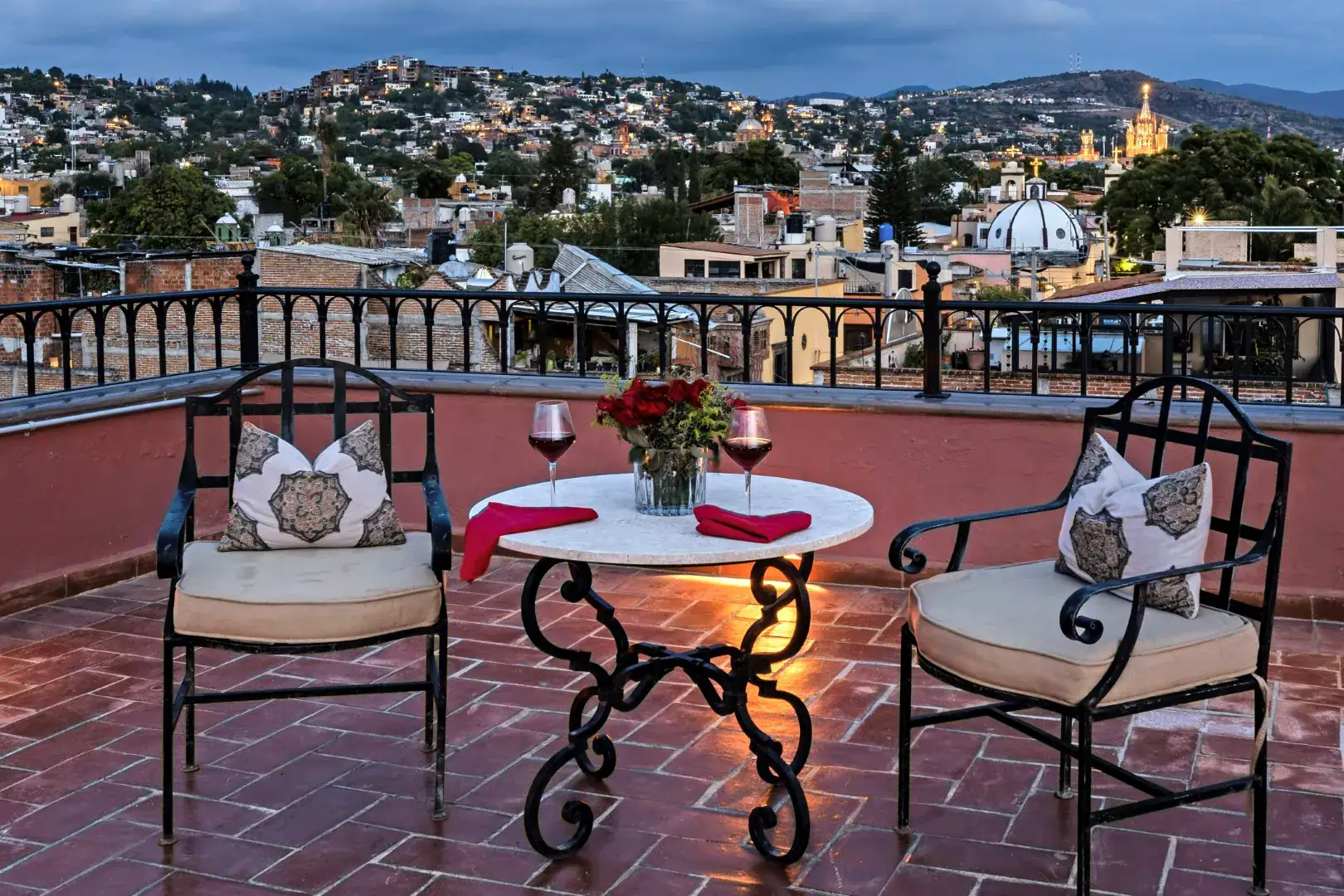 Casa Lua, rooftop terrace with a bistro table and a view of the church domes, San Miguel de Allende