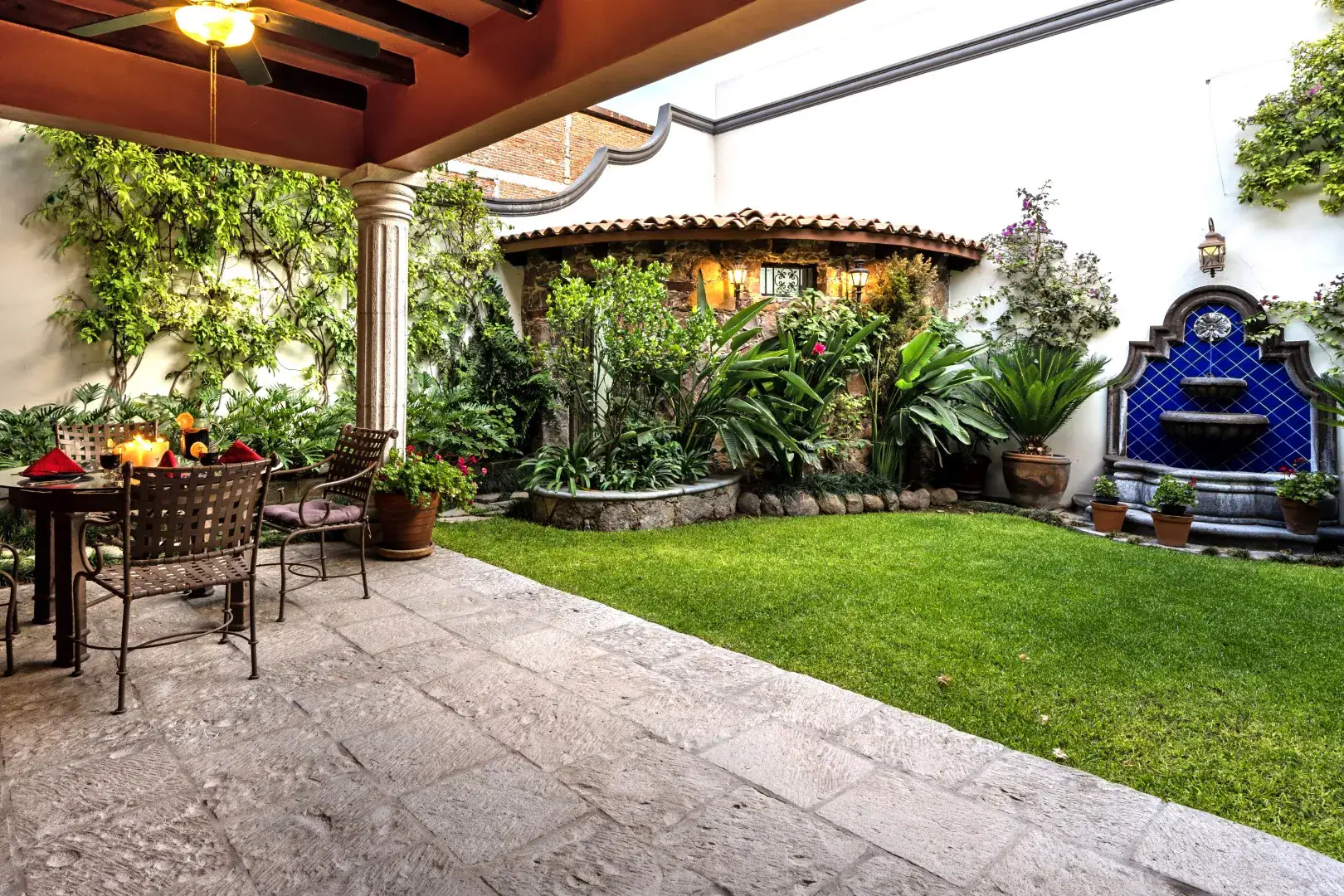 Casa Lua, courtyard garden with a lawn, a blue tile fountain and a covered seating area, San Miguel de Allende