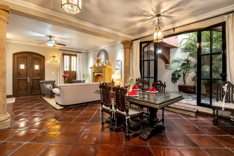 Casa Lua, living and dining area with a long wood table and an arched entry, San Miguel de Allende