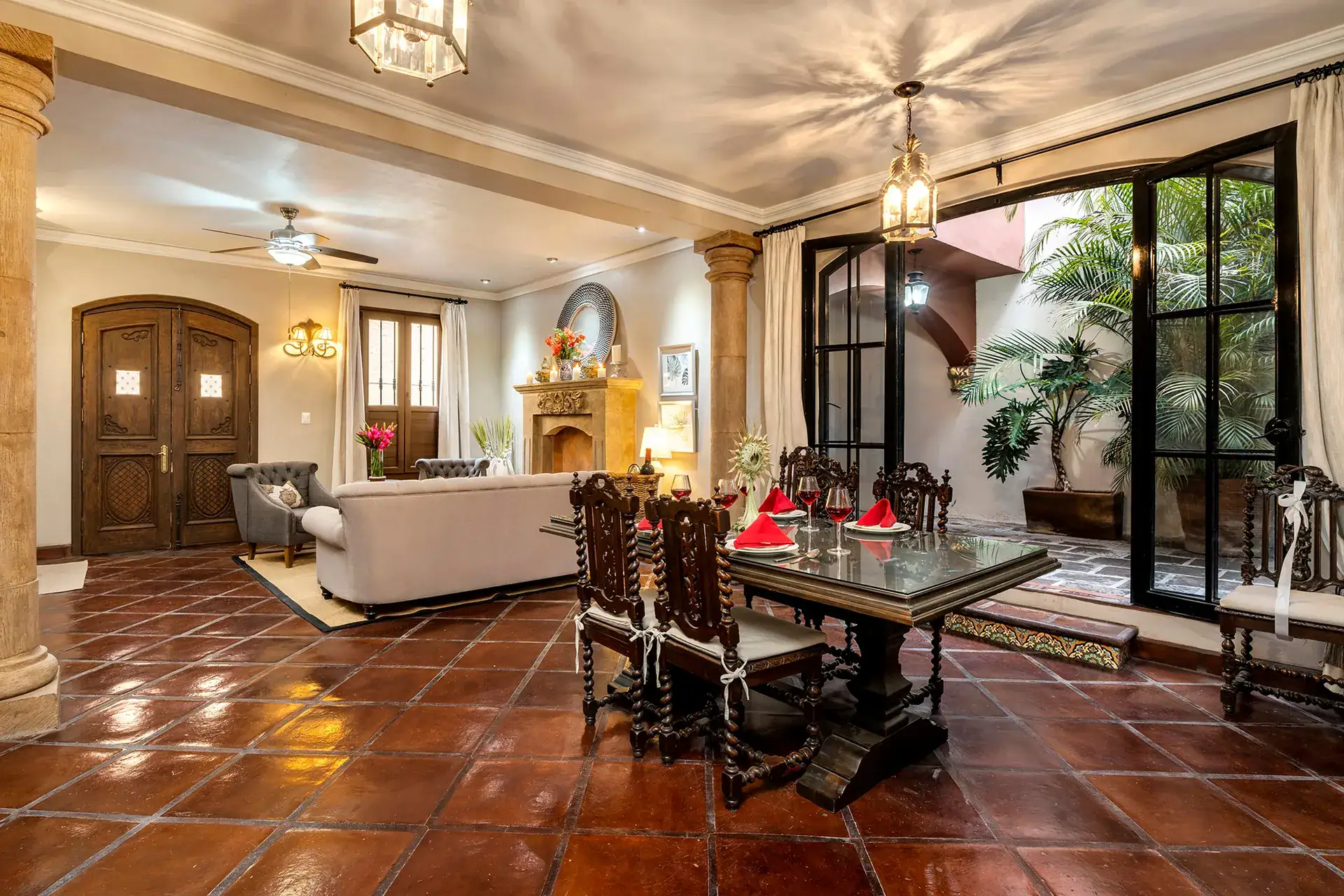 Casa Lua, living and dining area with a long wood table and an arched entry, San Miguel de Allende