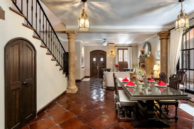 Casa Lua, entry hall with a carved wood door and a staircase, San Miguel de Allende