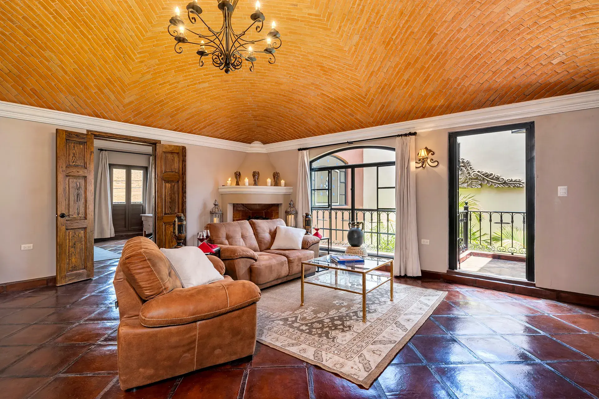 Casa Lua, upstairs sitting room with a corner fireplace and leather sofas, San Miguel de Allende