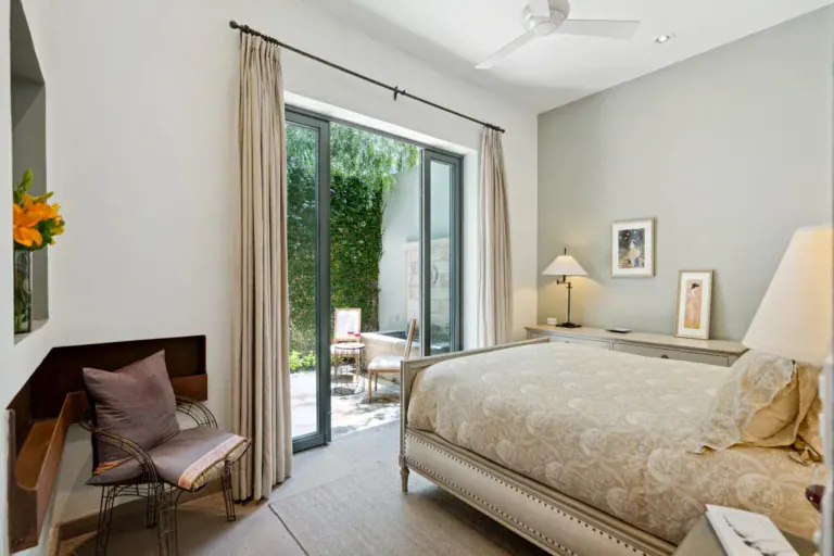 Casa Lula, primary bedroom with a cream bed and sliding glass doors to the garden, San Miguel de Allende
