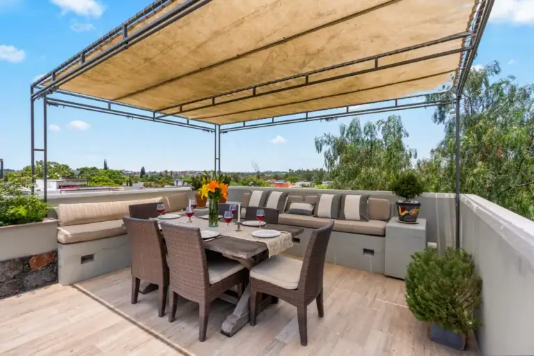 Casa Lula, rooftop terrace with a dining set and a built-in sofa above the neighborhood, San Miguel de Allende
