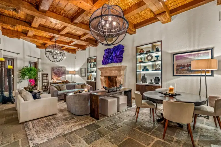 Casa Luz, great room with a stone fireplace, built-in shelves and a round chandelier, San Miguel de Allende