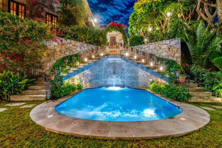 Casa Luz, illuminated pool with a waterfall at dusk, San Miguel de Allende