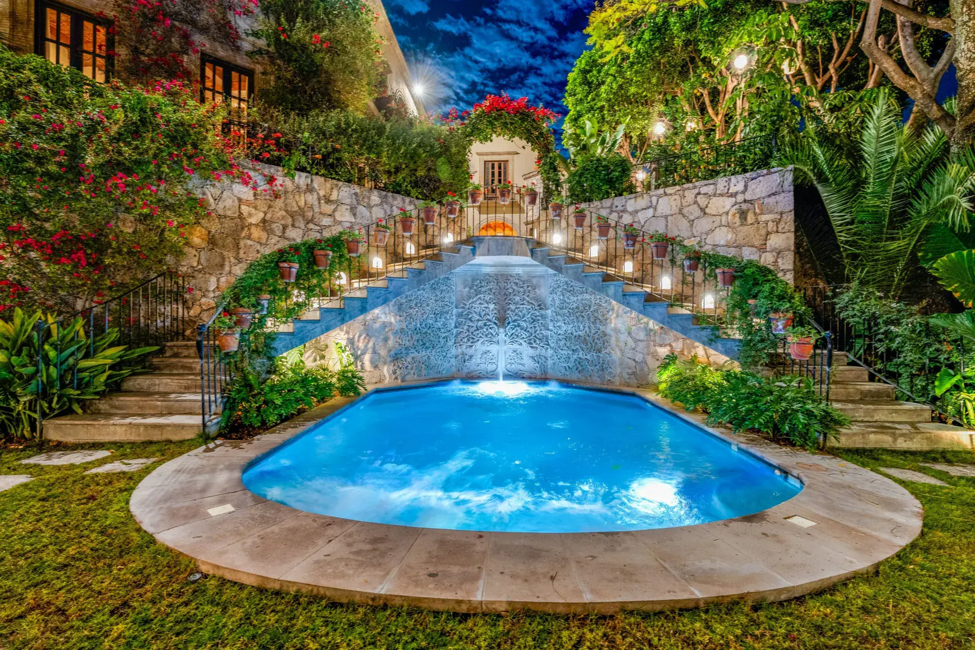 Casa Luz, illuminated pool with a waterfall at dusk, San Miguel de Allende