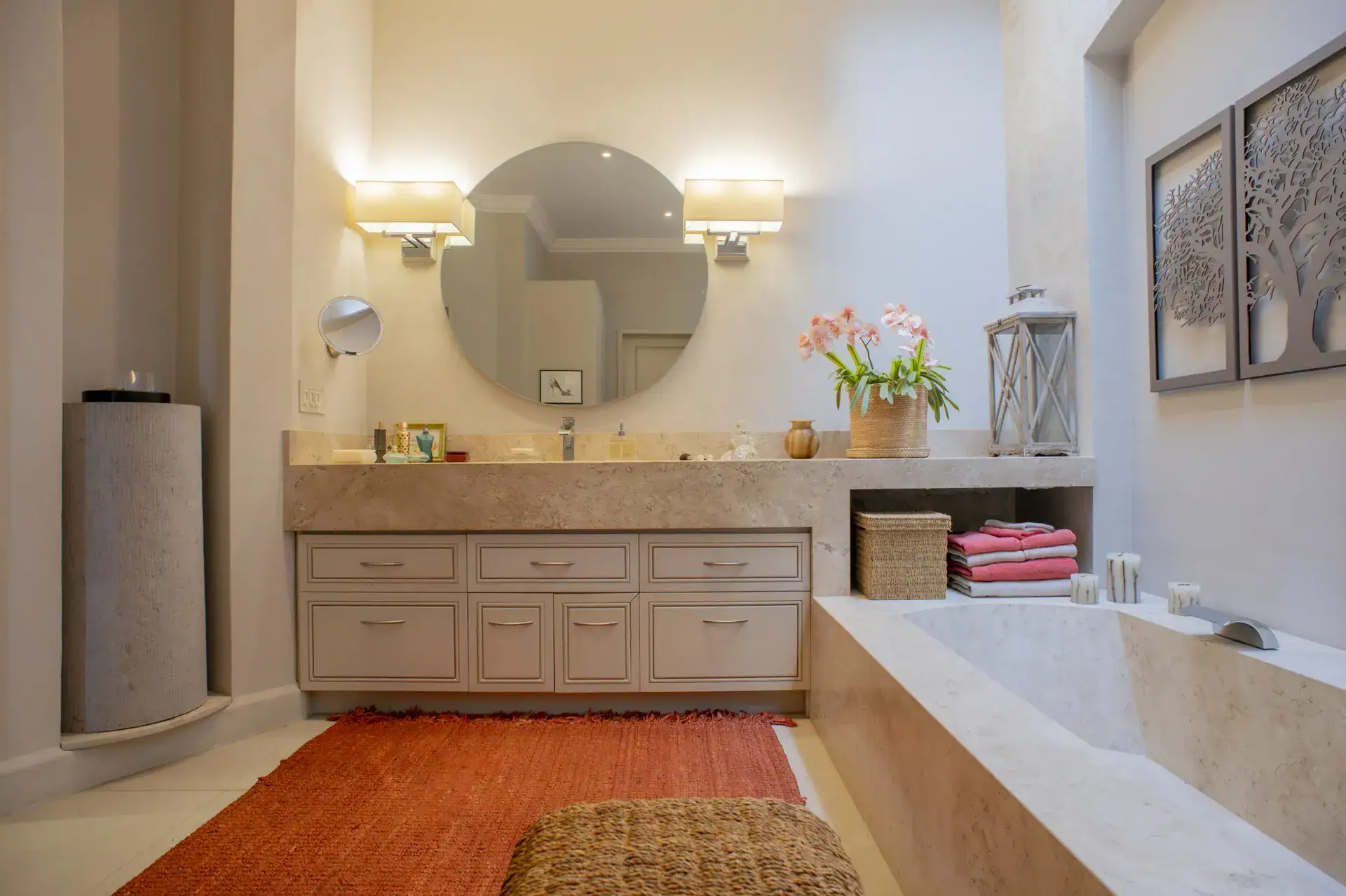 Casa Lyla, bathroom with a stone soaking tub, a round mirror and a long vanity, San Miguel de Allende