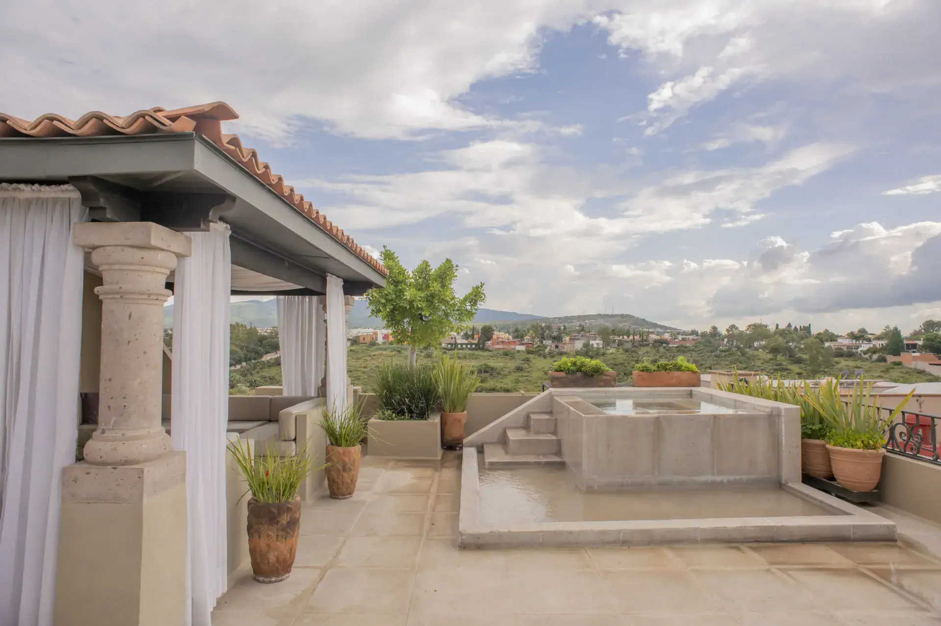 Casa Lyla, rooftop terrace with a stone plunge pool and a covered pavilion overlooking the valley, San Miguel de Allende