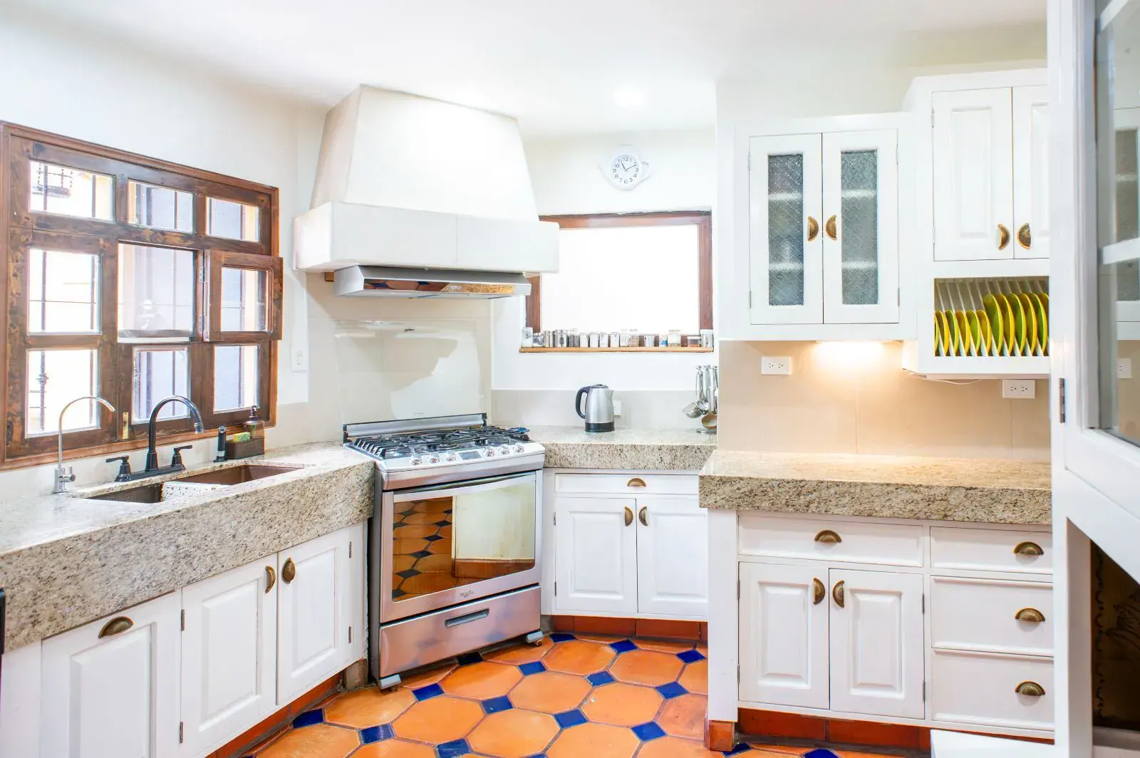 Casa Mexicana, kitchen with white cabinets, a stone sink counter, a stainless range and a blue and orange tile floor, San Miguel de Allende