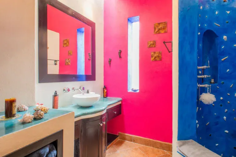 Casa Mexicana, bathroom with a magenta wall, a turquoise vanity with a vessel sink and a blue shell-mosaic shower, San Miguel de Allende