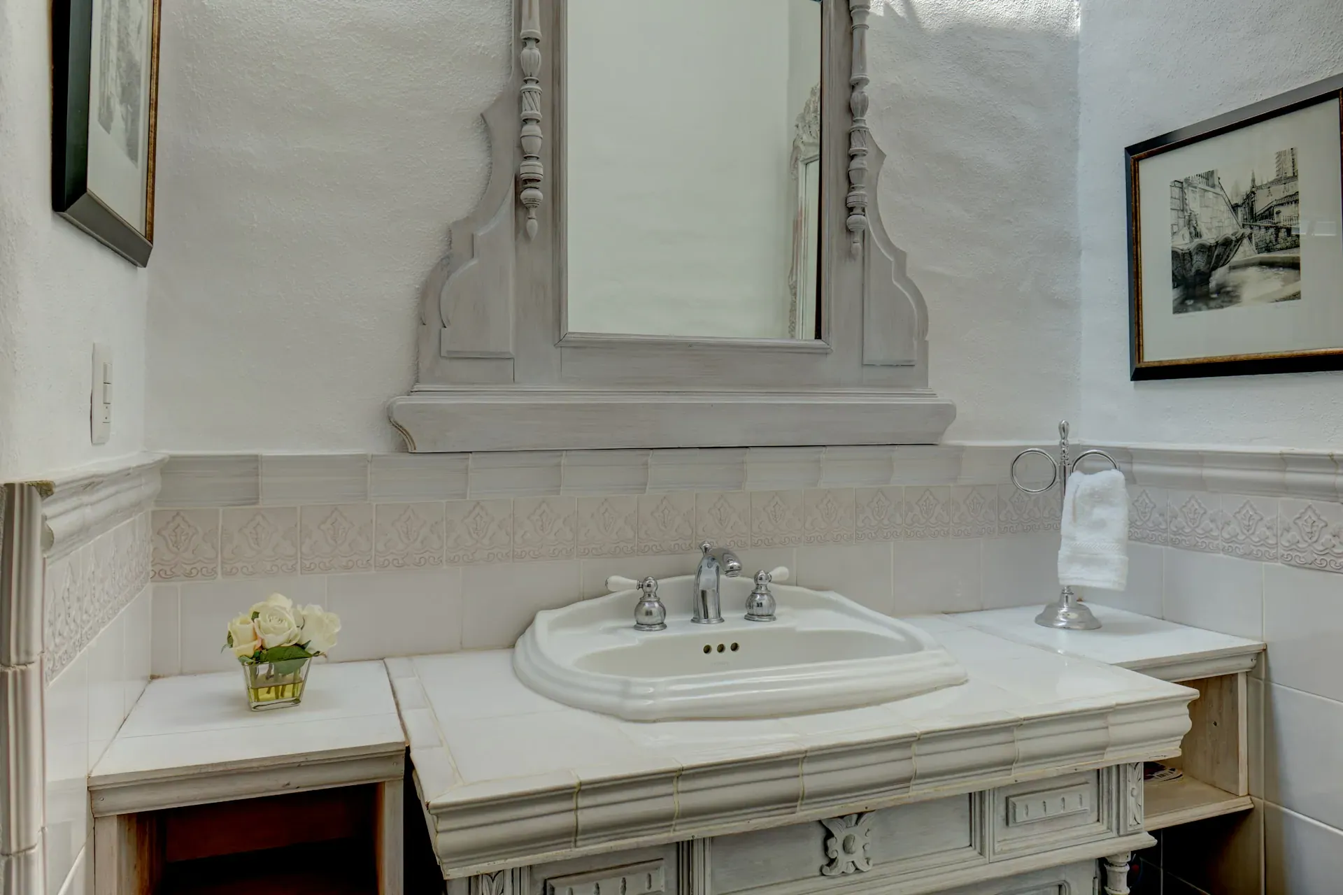 Casa Mi Besito, bathroom with a carved stone vanity, a white basin and a tall ornate mirror, San Miguel de Allende