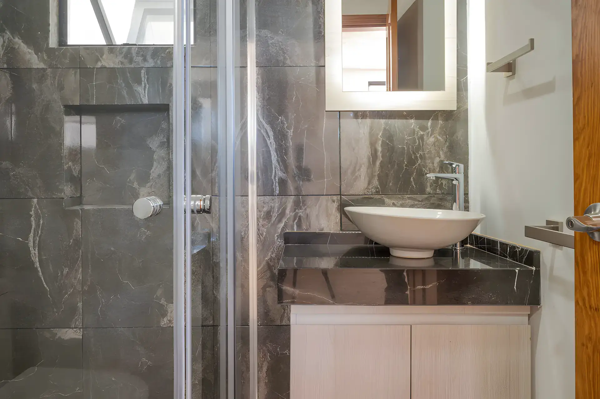 Casa Milagros, bathroom with a gray marble shower, a white vessel sink and a black marble counter, San Miguel de Allende