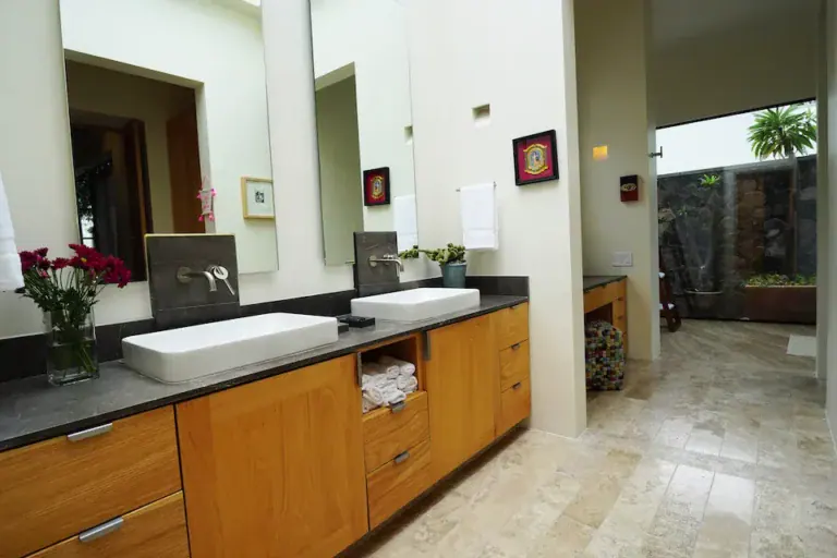 Casa Mojica, bathroom with a double vanity and wood cabinets, San Miguel de Allende