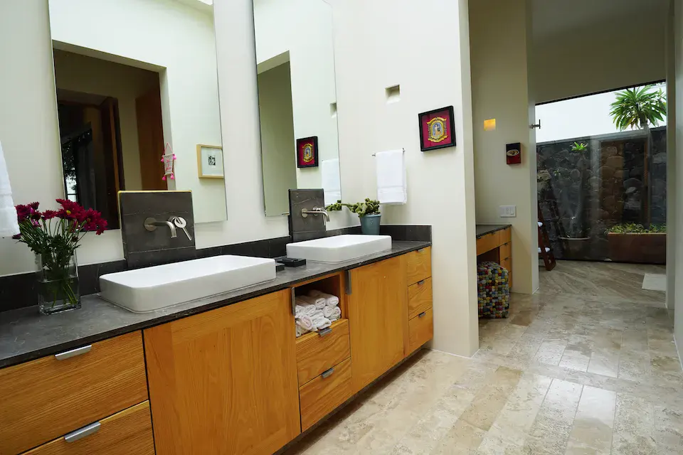 Casa Mojica, bathroom with a double vanity and wood cabinets, San Miguel de Allende