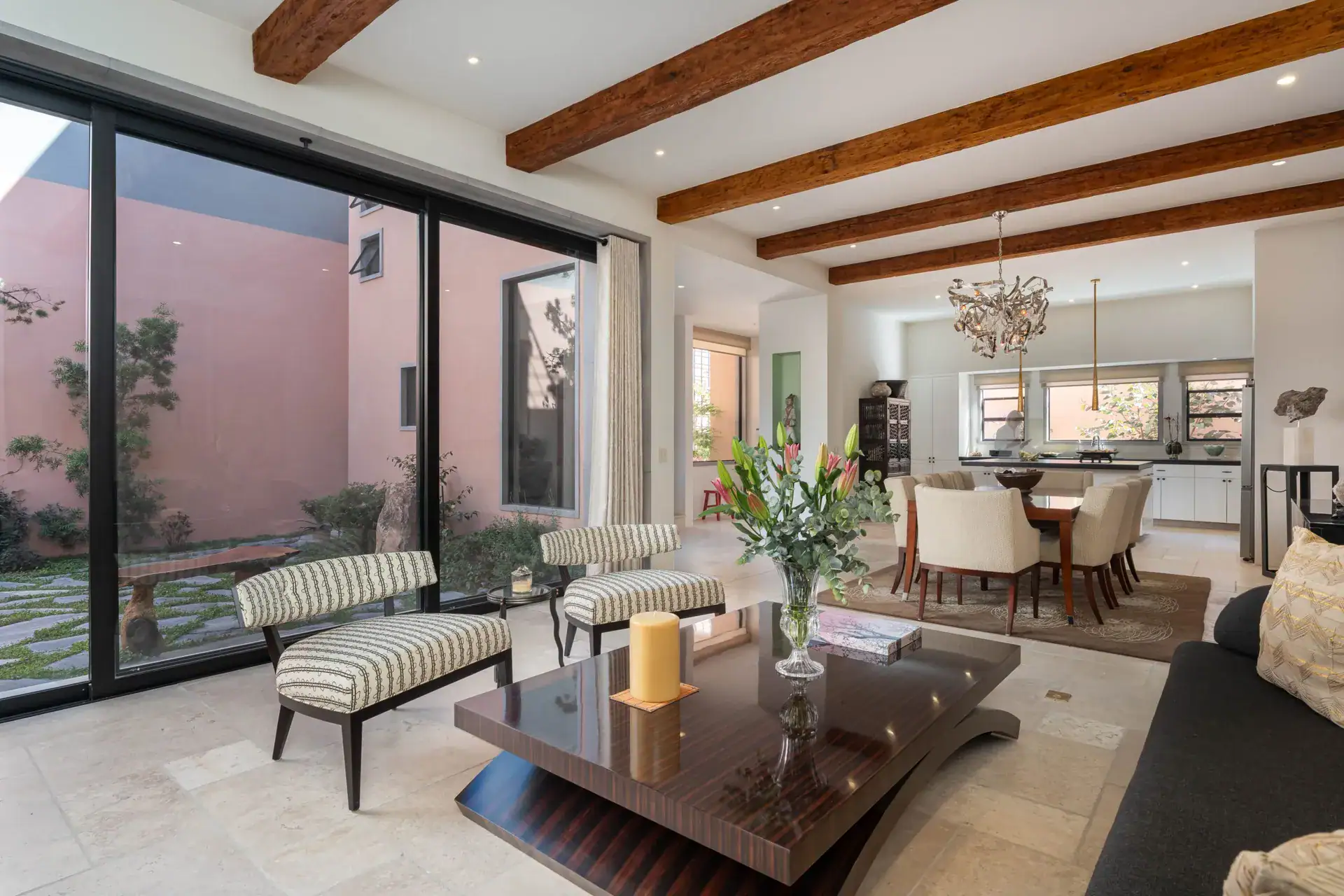 Casa Nobel, living room and dining room with a view through a wall of glass to the courtyard, San Miguel de Allende