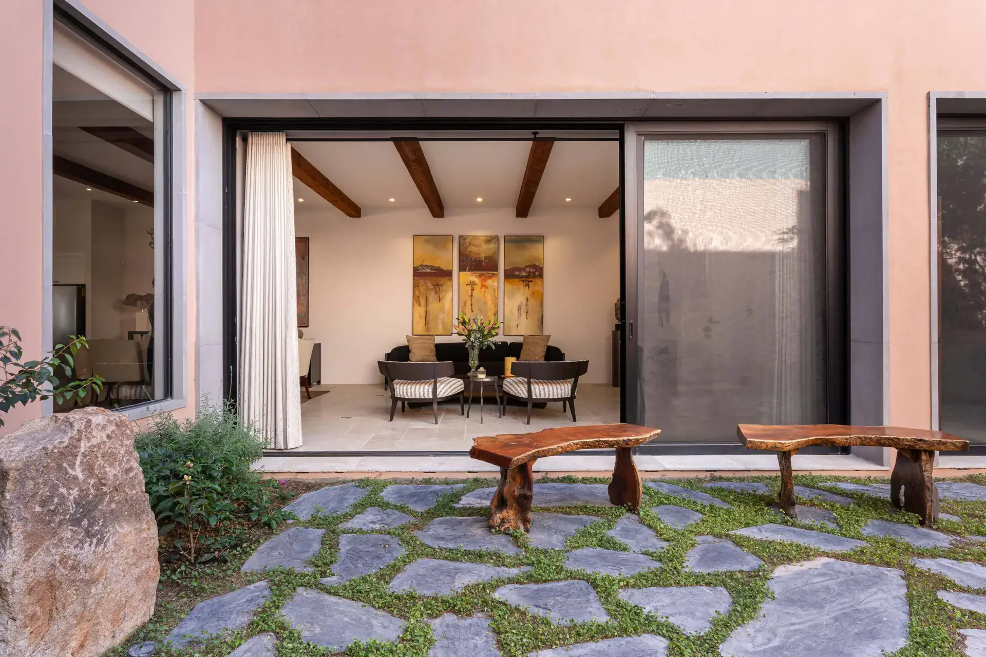 Casa Nobel, view from the courtyard into the living room through sliding glass doors, San Miguel de Allende