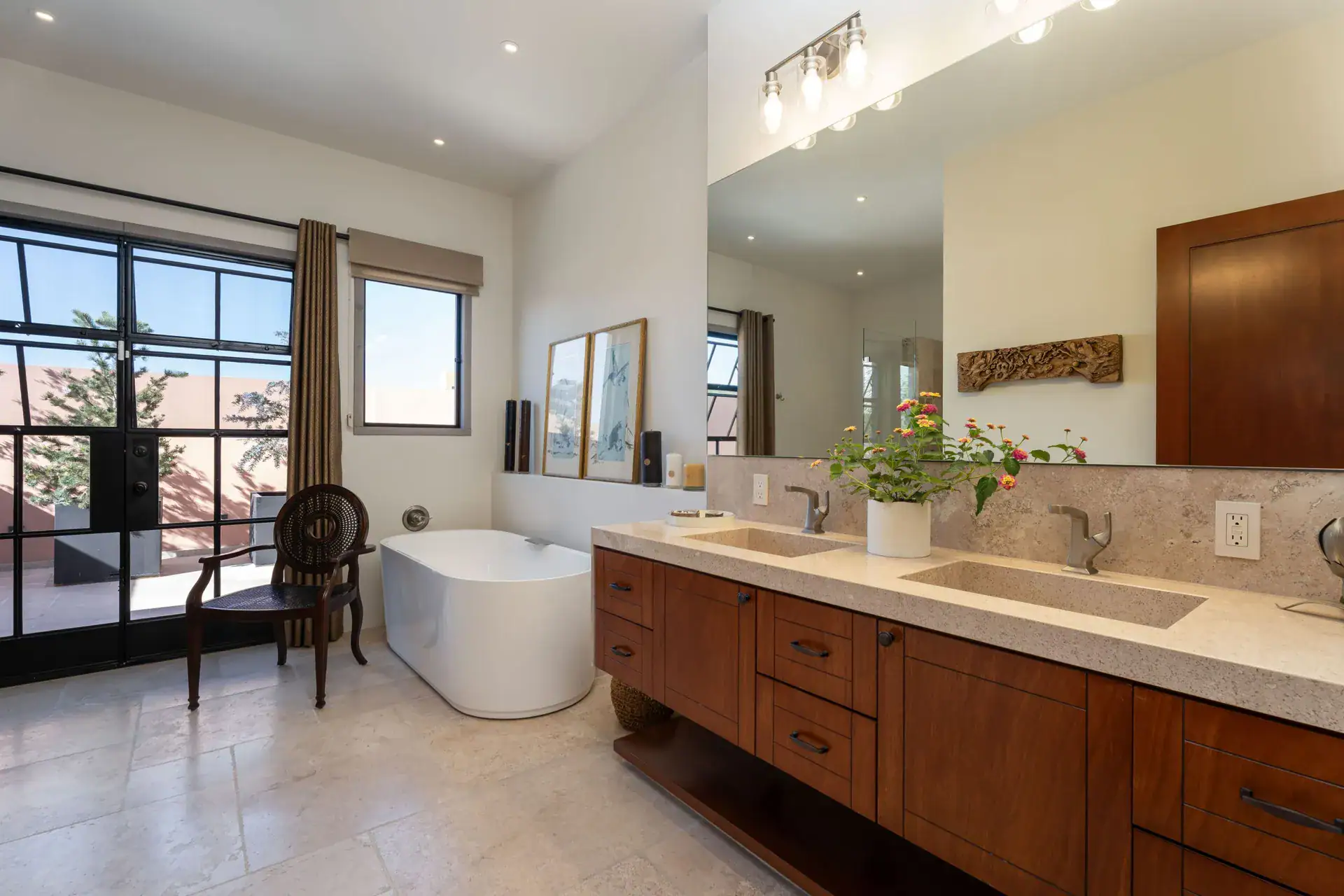 Casa Nobel, bathroom with a freestanding tub, a long wood vanity and a glass door to a balcony, San Miguel de Allende