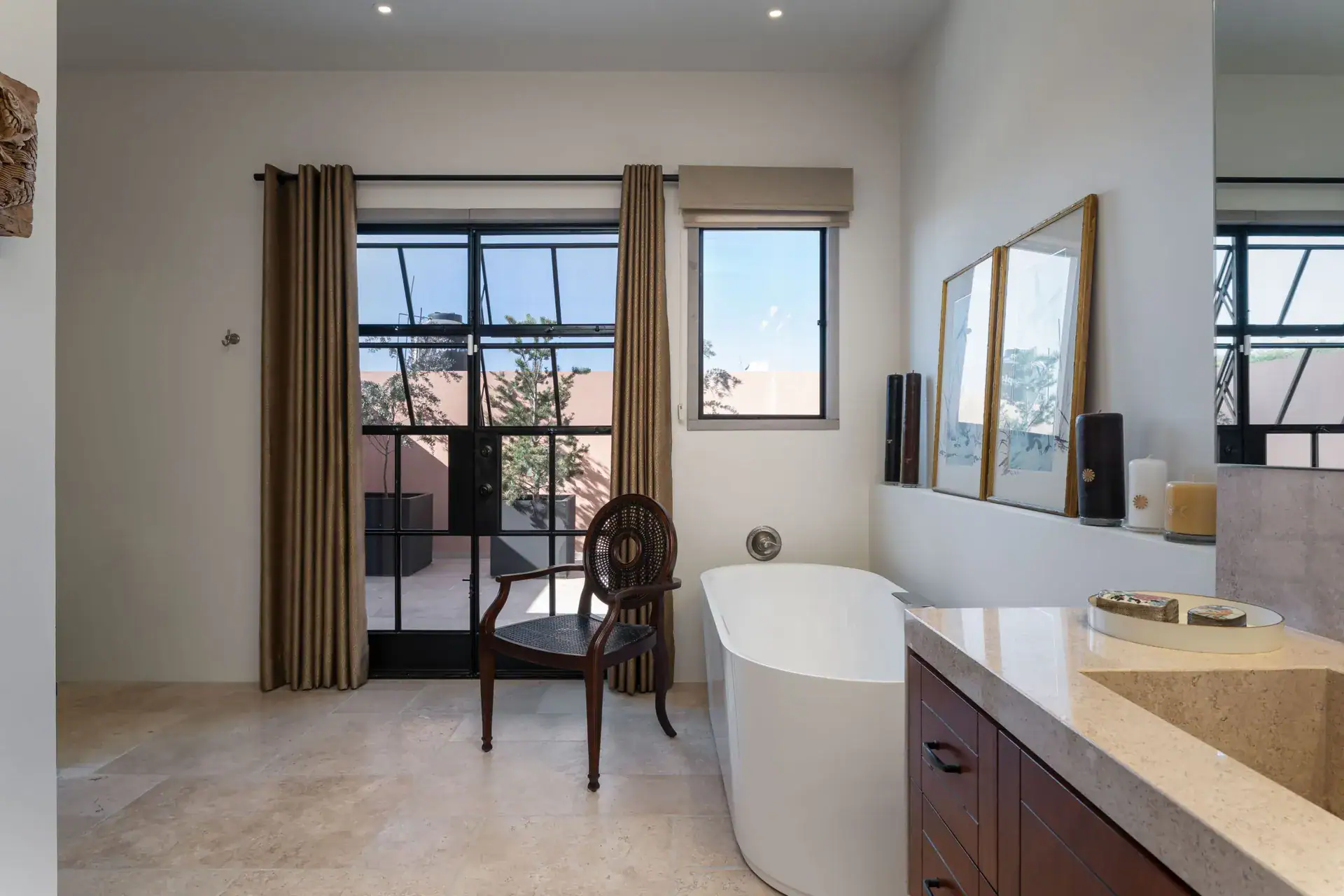 Casa Nobel, bathroom with a freestanding tub and a view through glass doors to the terrace, San Miguel de Allende