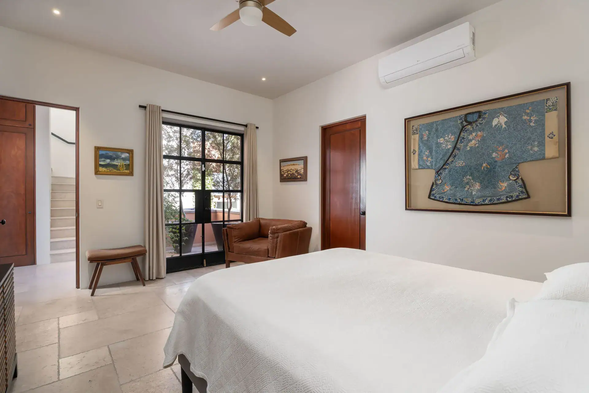 Casa Nobel, bedroom with a framed blue silk robe and a leather armchair, San Miguel de Allende