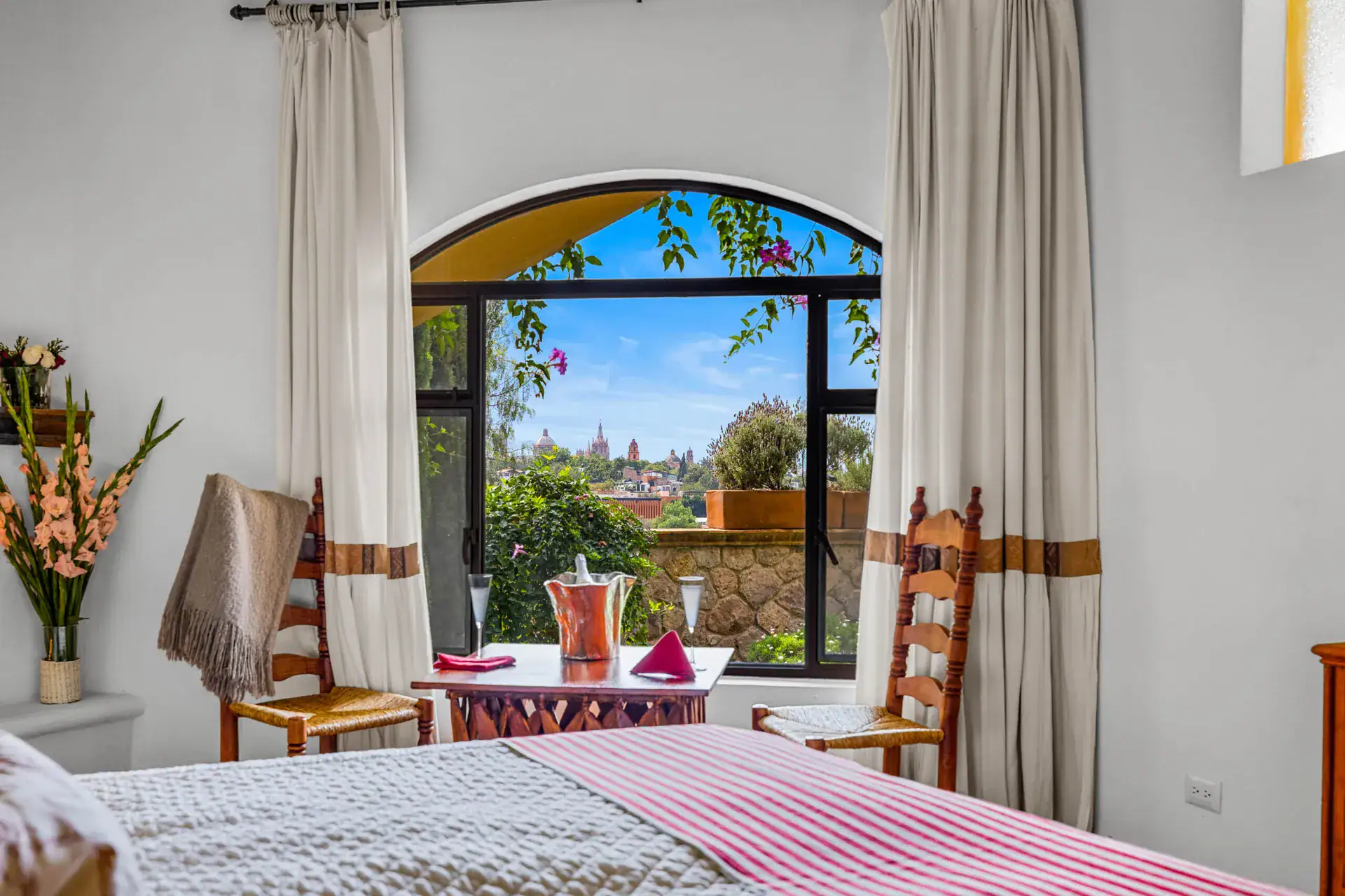 Casa Noche Magica, guest bedroom window with a view to the hills and domes of the town, San Miguel de Allende