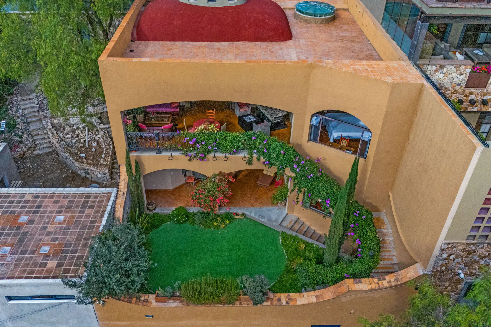 Casa Noche Magica, aerial view of the house with a green lawn terrace and arched loggias, San Miguel de Allende