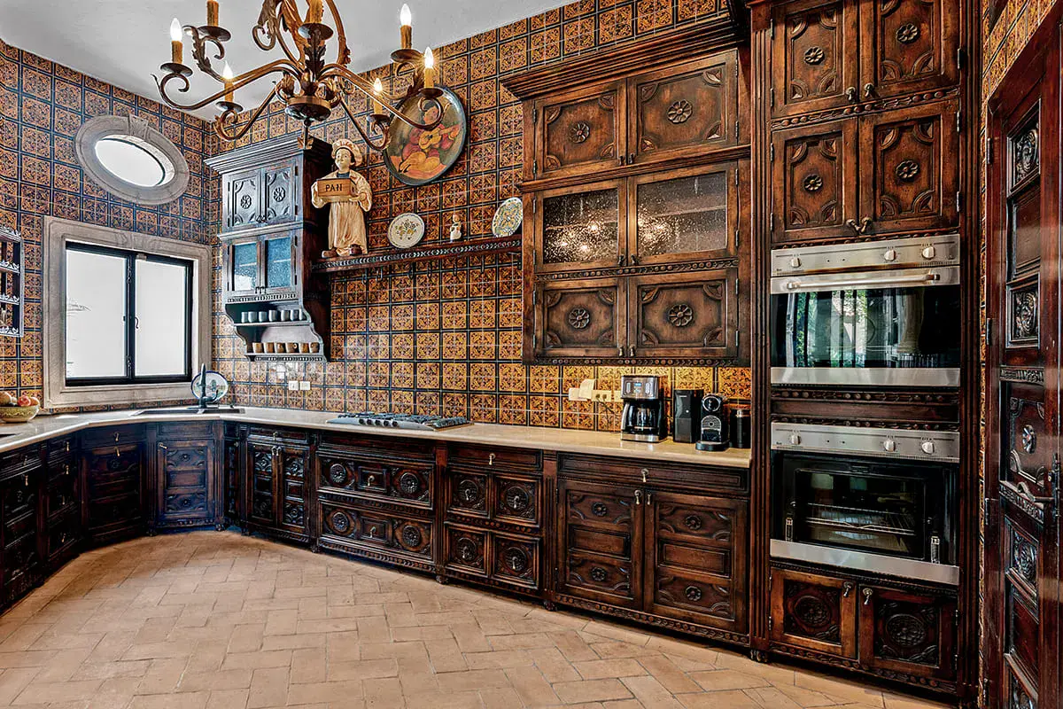Casa Nola, kitchen with carved wood cabinets and talavera tile, San Miguel de Allende