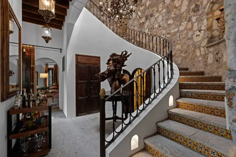Casa Nola, staircase with a curved stone wall and painted tile risers, San Miguel de Allende
