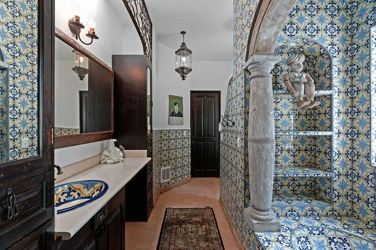Casa Nola, bathroom with a talavera tile shower and a carved stone column, San Miguel de Allende