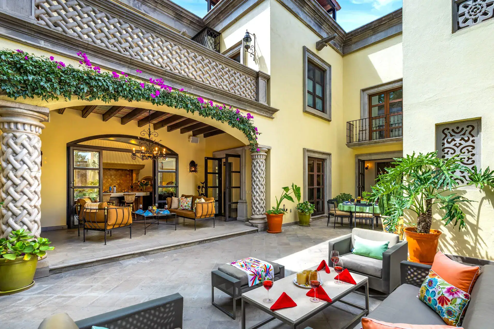 Casa Nostra Familia, courtyard with a vine-covered arcade and twisted stone columns, San Miguel de Allende