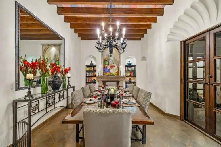 Casa Nostra Familia, dining room with a long wood table and a wrought-iron chandelier, San Miguel de Allende