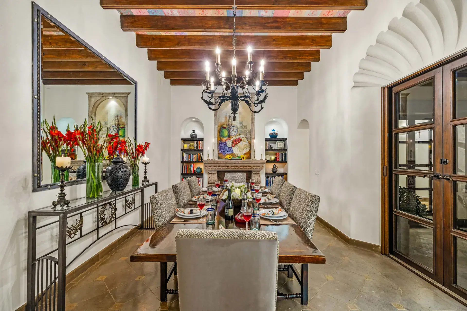 Casa Nostra Familia, dining room with a long wood table and a wrought-iron chandelier, San Miguel de Allende