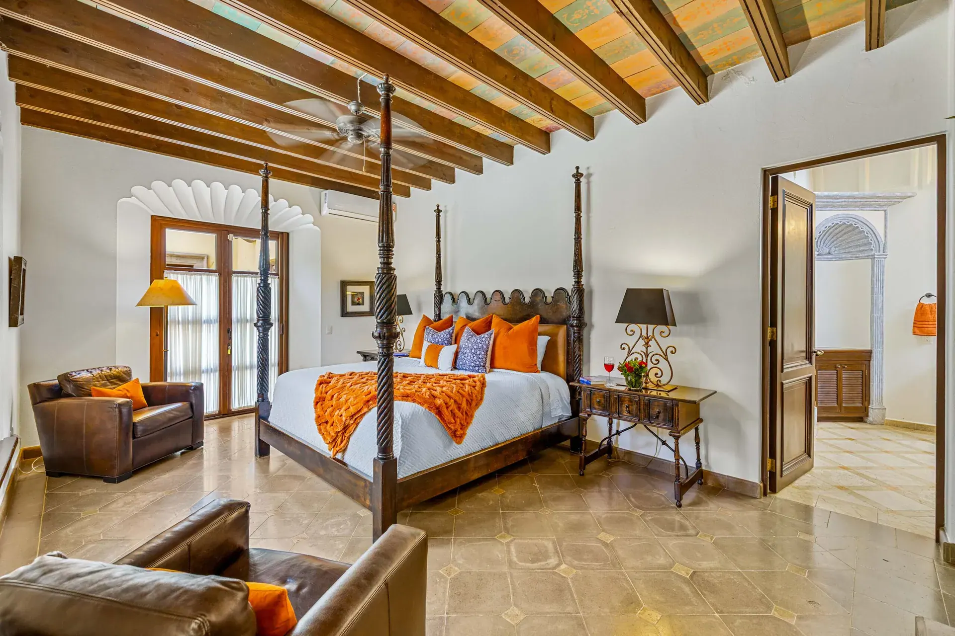 Casa Nostra Familia, primary bedroom with a carved four-poster bed and a beamed ceiling, San Miguel de Allende