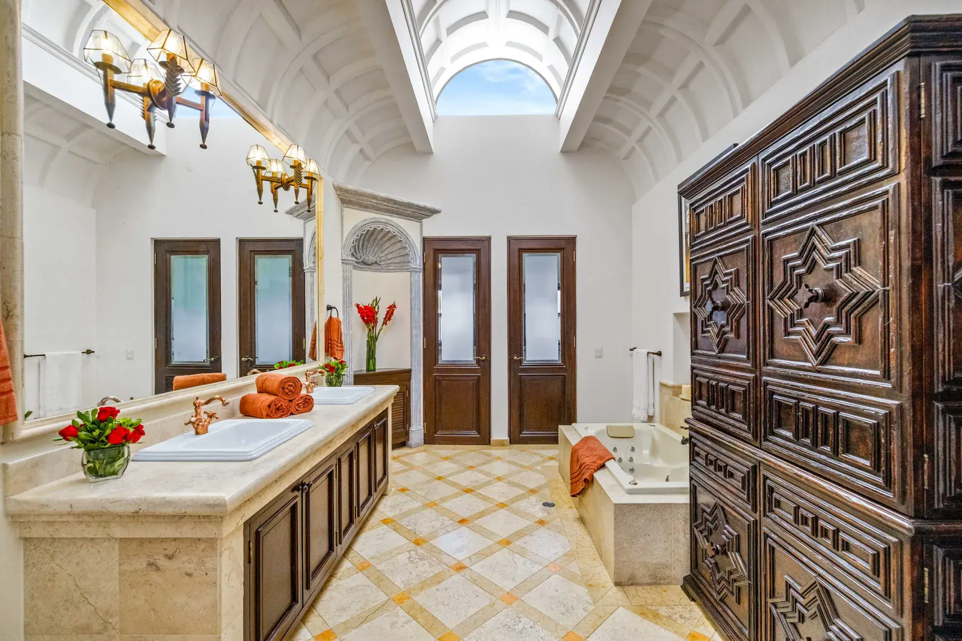 Casa Nostra Familia, bathroom with a stone vanity, a skylight and carved wood doors, San Miguel de Allende