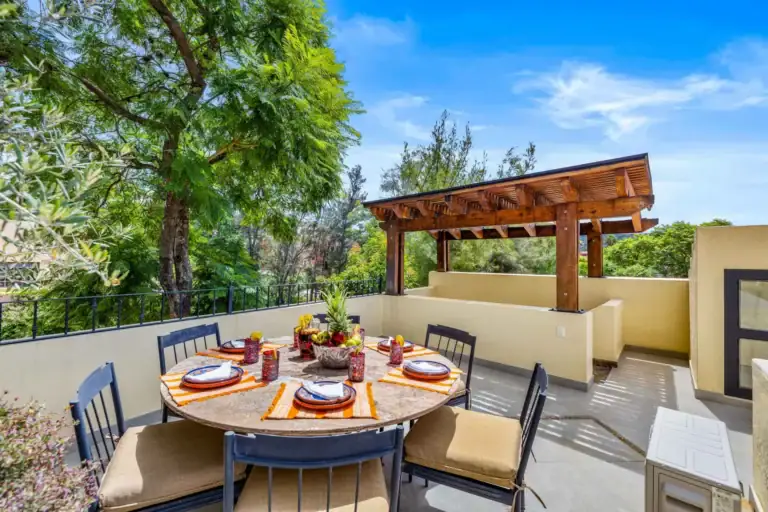 Casa Nostra Familia, rooftop terrace dining table under a wood pergola, San Miguel de Allende