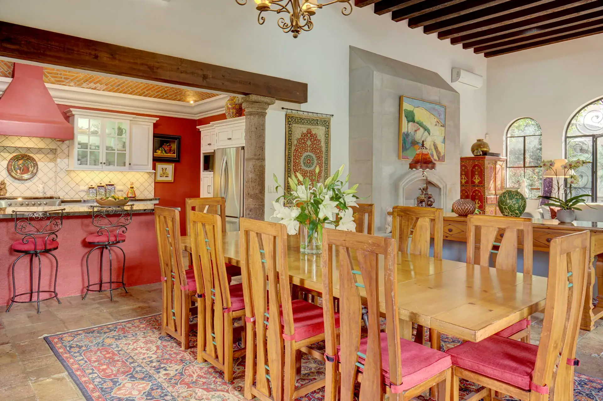 Casa Oasis, dining table and open kitchen with a red range hood, San Miguel de Allende