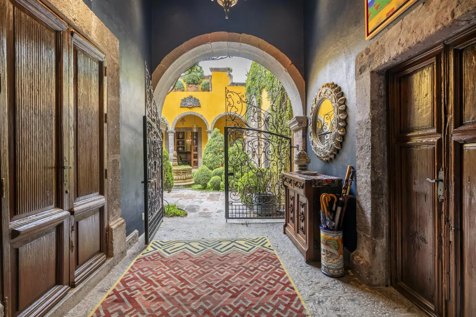 Casa Obelisco, carved wood entrance doors and an arch opening onto the courtyard, San Miguel de Allende