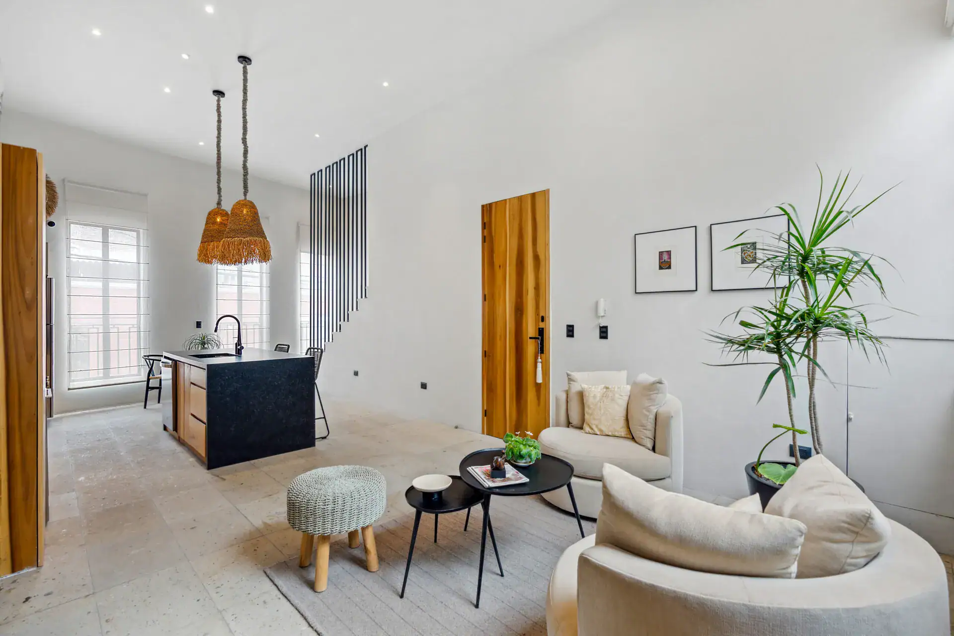Casa Palma, kitchen island with stools and a living area with a round-armed sofa, San Miguel de Allende