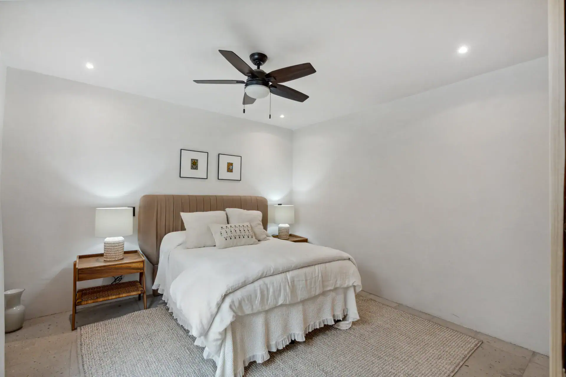 Casa Palma, bedroom with a tan headboard, white bedding, a ceiling fan and wood bedside tables, San Miguel de Allende