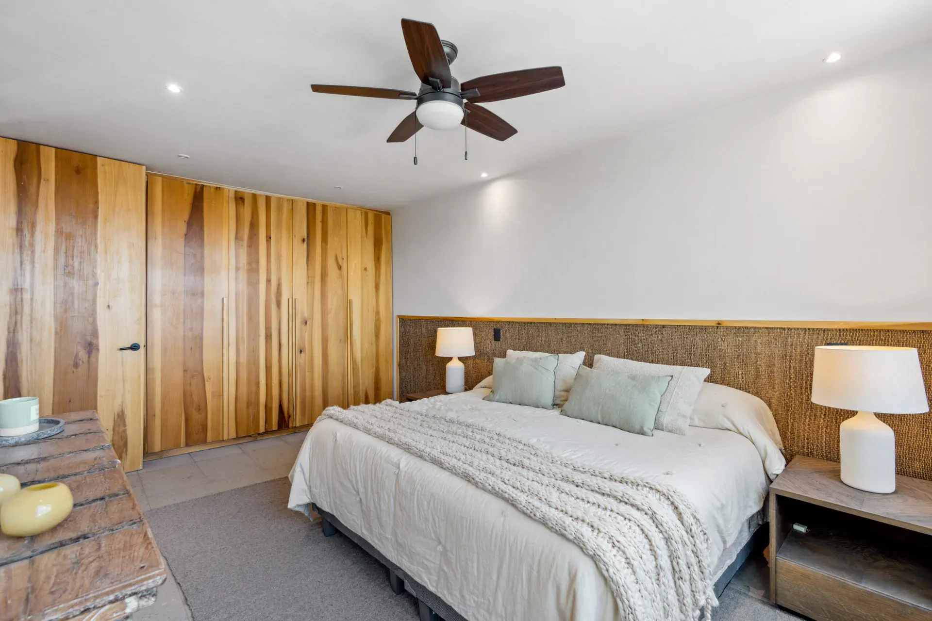 Casa Palma, bedroom with built-in wood closets, a ceiling fan and a white bed, San Miguel de Allende