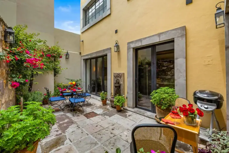 Casa Paradise, yellow stucco house with a flagstone courtyard and bougainvillea, San Miguel de Allende